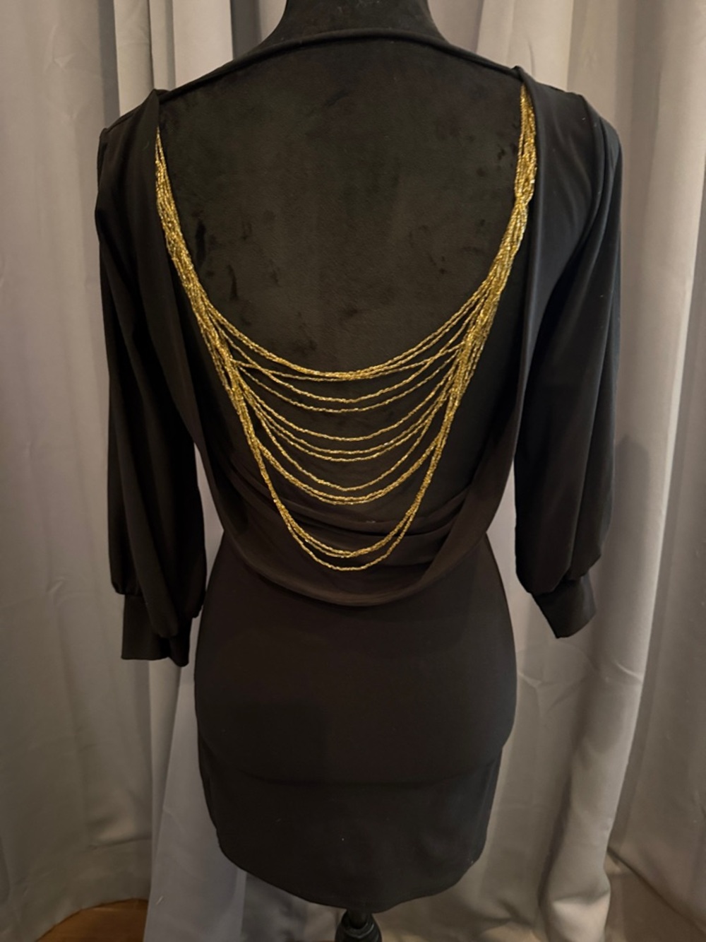 Forplay Classic Black Long-Sleeve Sheath Dress with gold chains on back.